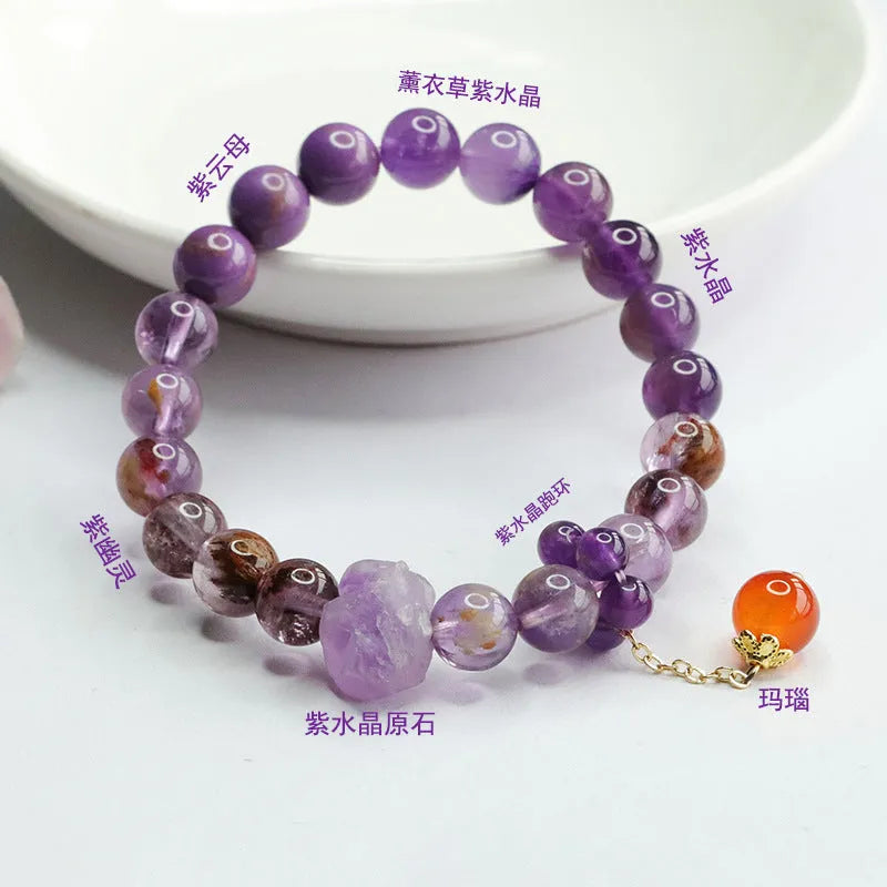Nine purple fire amethyst and red agate Mori-style crystal bracelet on a wrist.