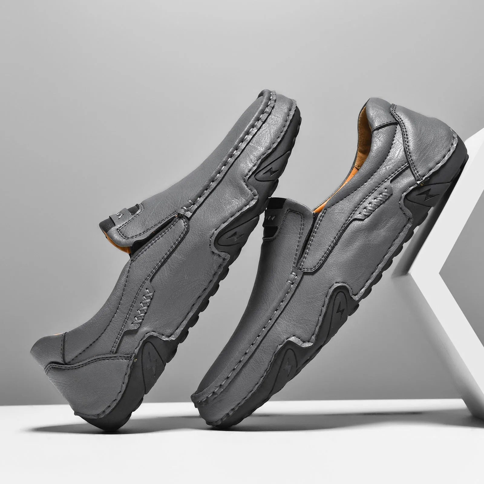 Casual slip-on shoes in multiple colours with a microfiber upper and flat rubber sole.