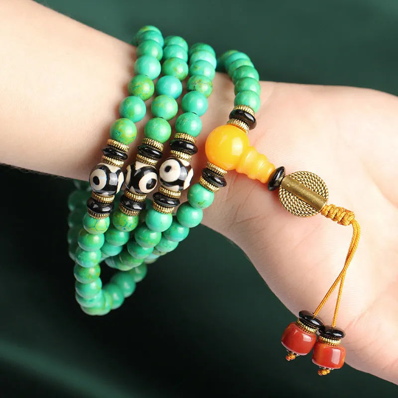 Natural turquoise bracelet with 108 round 8mm beads on a white background.