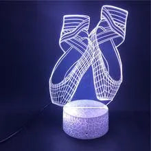 Ballet dancer 3D LED night light with remote control on a table.