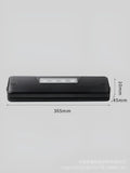 Small black automatic vacuum sealer machine for household food preservation on a kitchen counter