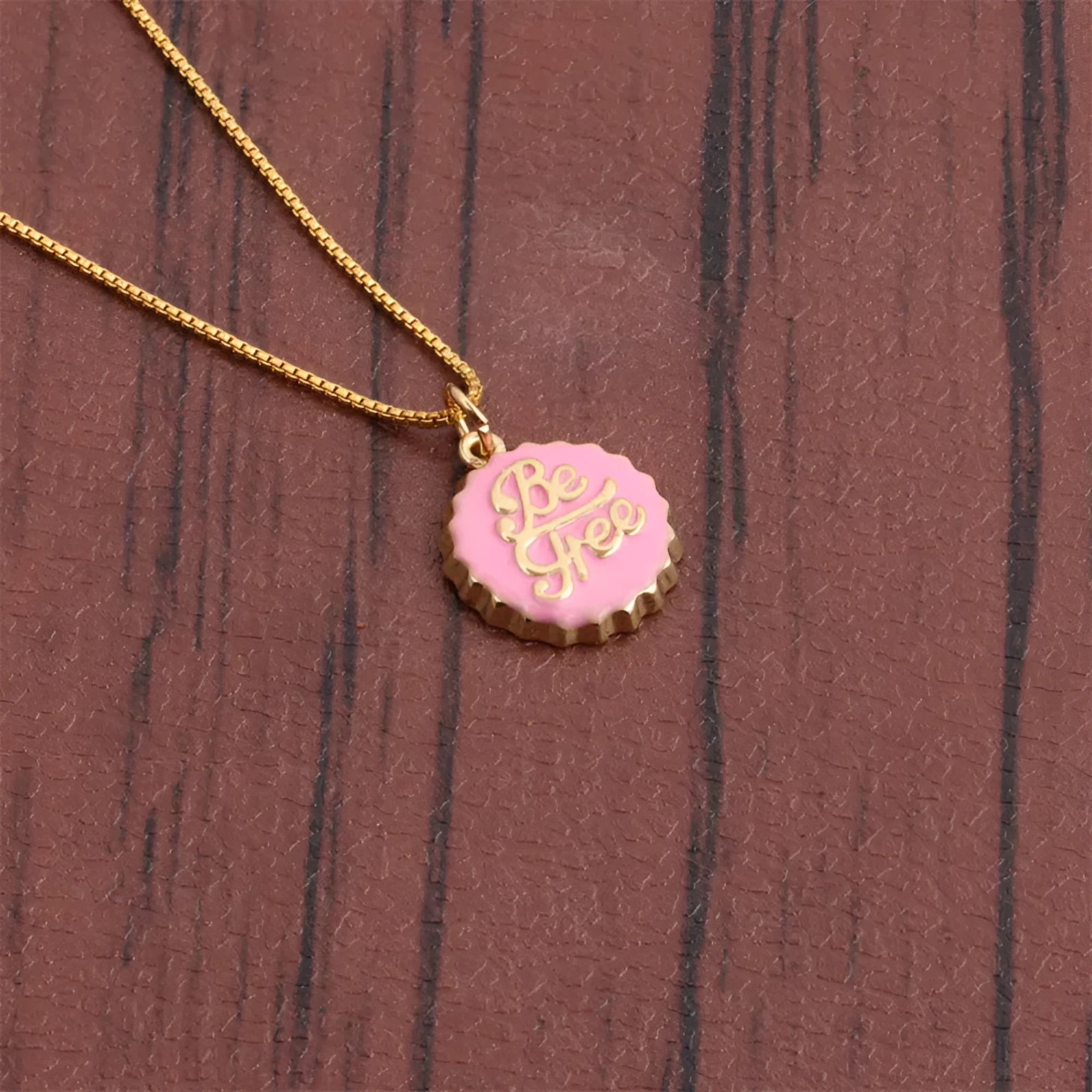 Copper bottle cap pendant necklace with a box chain in a choice of six electroplated colours.