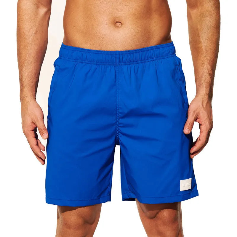 Men's nylon sports shorts in solid colours with straight leg opening and elastic waistband