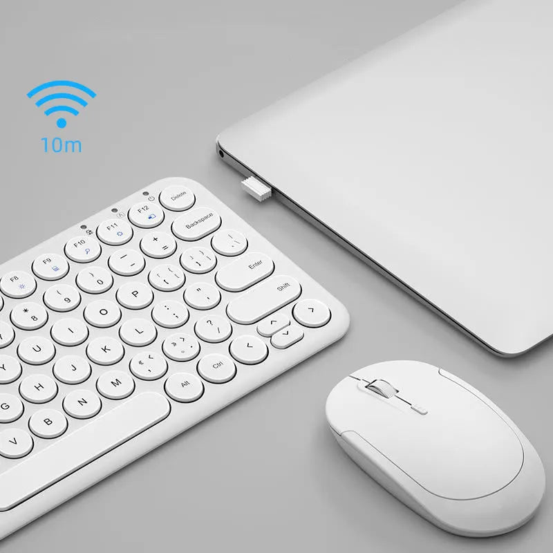 White ultra-thin wireless keyboard and mouse with USB receiver on a wooden desk