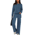 Women's black polyester two-piece leisure suit with long sleeves and trousers on a hanger.