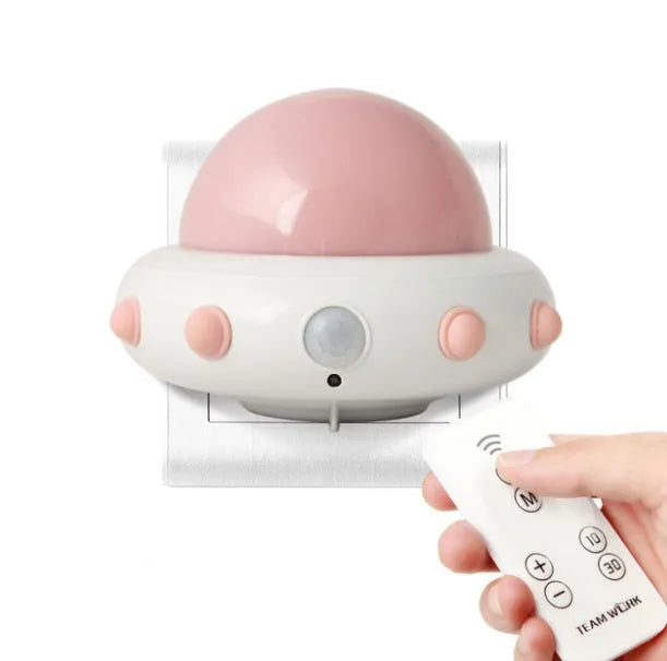 Remote control UFO-shaped bedside night light in blue, pink, or white with cartoon modern design