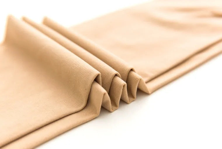 Beige and black stovepipe socks for hip and abdomen support, made from polyester fibre.