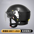Khaki coloured motorcycle half helmet with a long mirrored visor attached on a table.