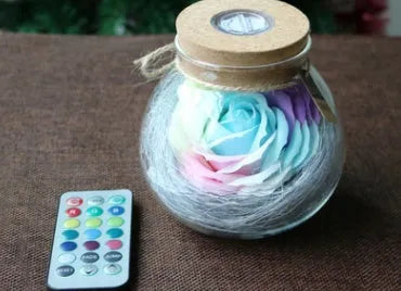 Colorful rose soap flower in glass wishing bottle with four colour options for decor or gift