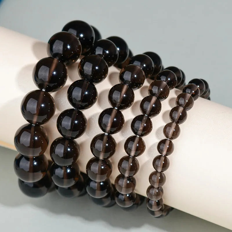 Hand-woven obsidian couples bracelet with year of birth engraving and multiple bead diameter options
