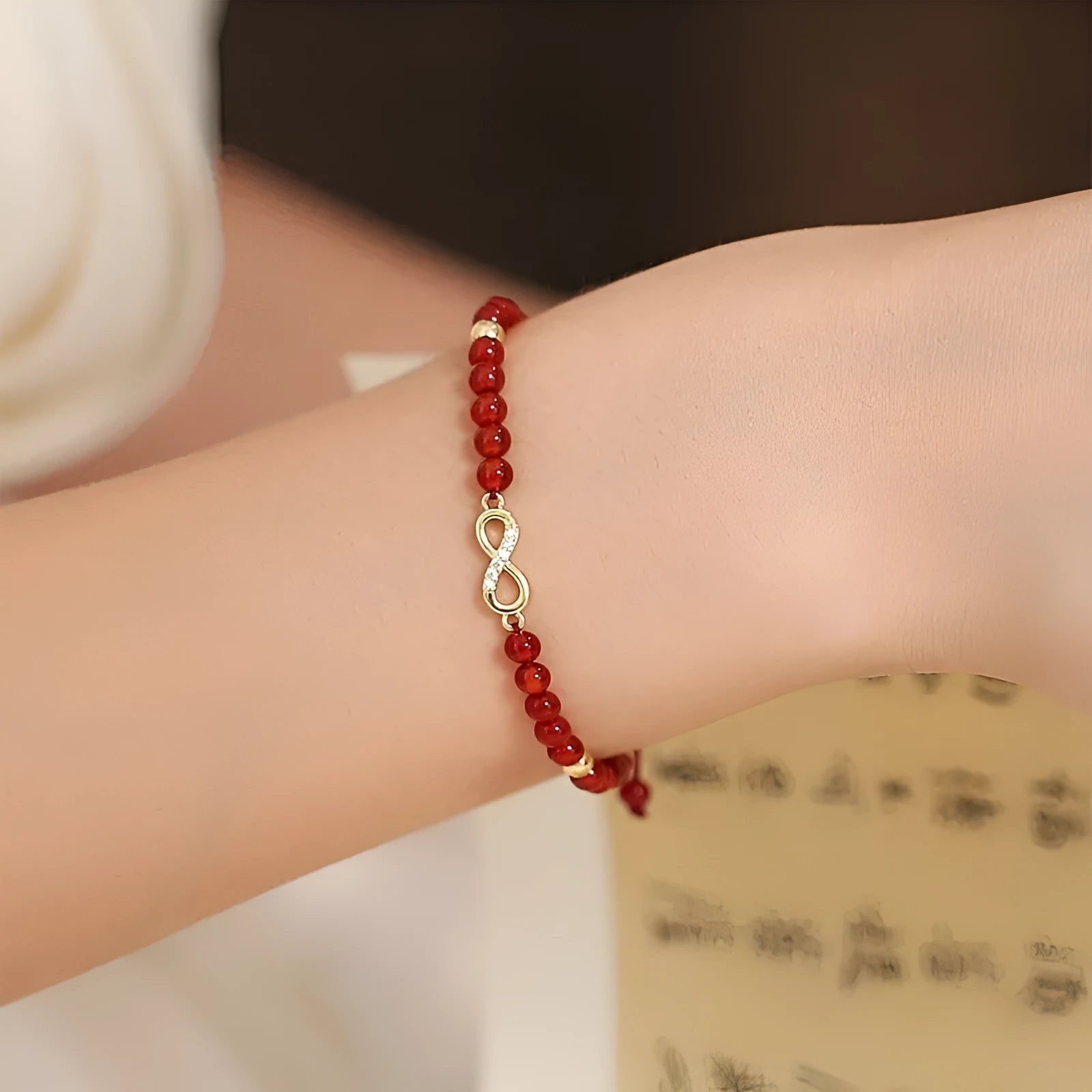 Hand-woven natural red agate bracelet showing diamond-shaped beads in ethnic woven pattern