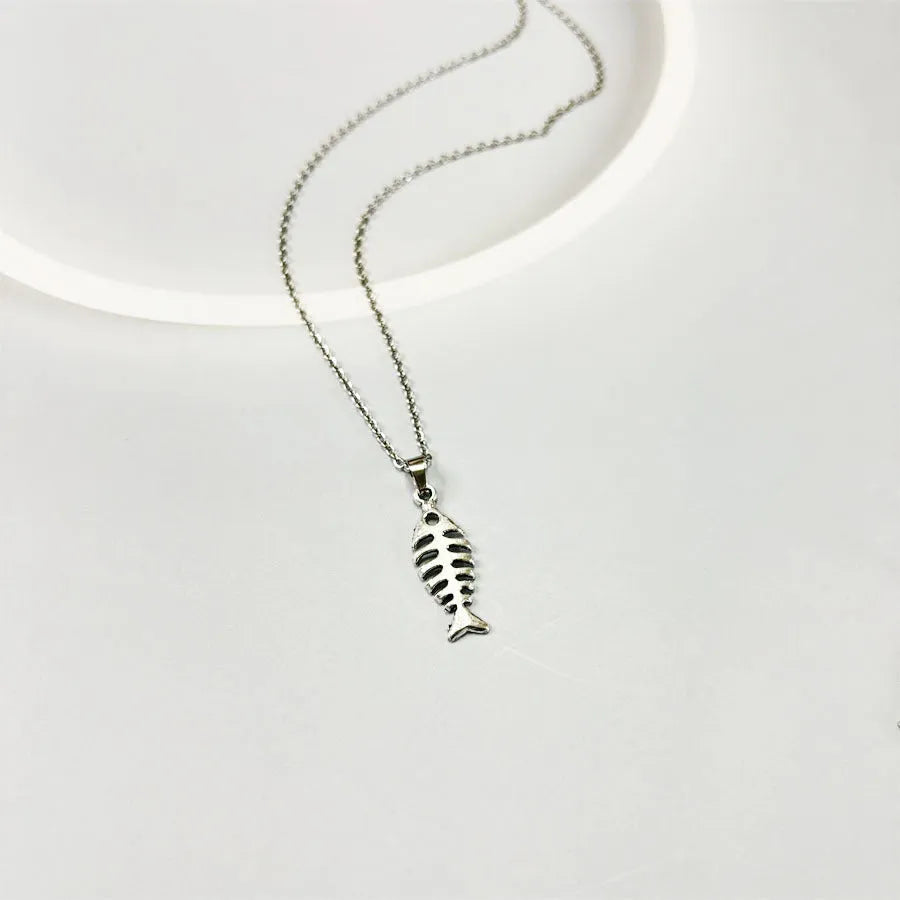 Close-up of retro-style fishbone pendant earrings on an adjustable O-chain.