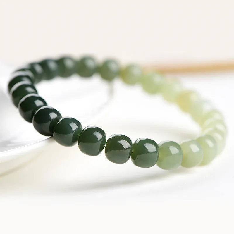 Natural Hetian jade bracelet with gradient clear water colour and polished beads.