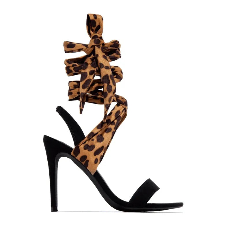Light brown leopard print women's high heels with cross straps and an 8cm slim heel on a rubber sole.