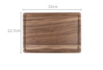 Solid black walnut wood chopping board with juice groove, available in round or rectangular sizes.