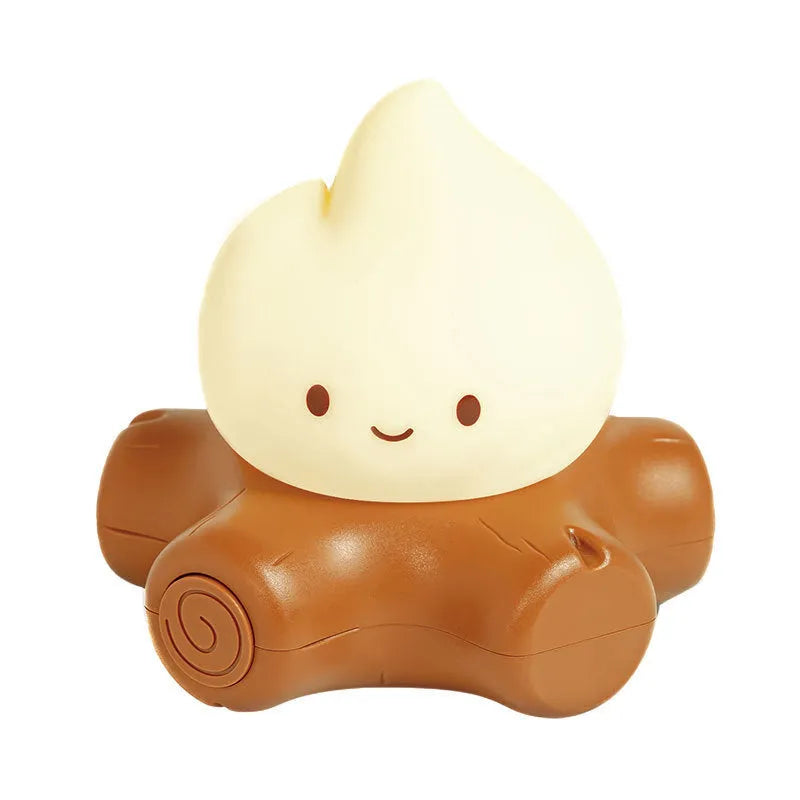 Silicone small fire pile cartoon night lamp with ABS shade on a surface.