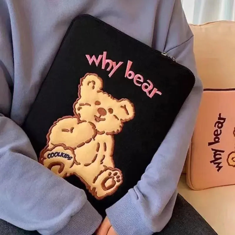 Embroidered animal design laptop sleeve in polyester, shown next to a laptop.