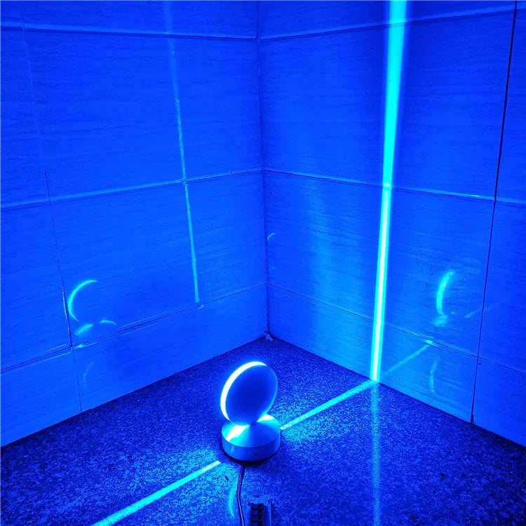 Modern aluminium LED bar wall lamp with glass lens, shown in a corridor setting.
