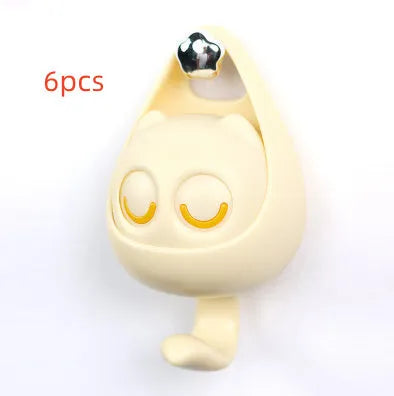 Cream white cat-shaped adhesive wall hook with winking eyes, 2.5kg capacity, 105x61x45mm