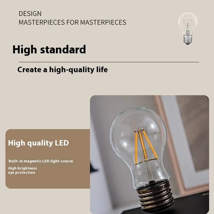 Iron art suspension bulb desktop night lamp on a black square base.