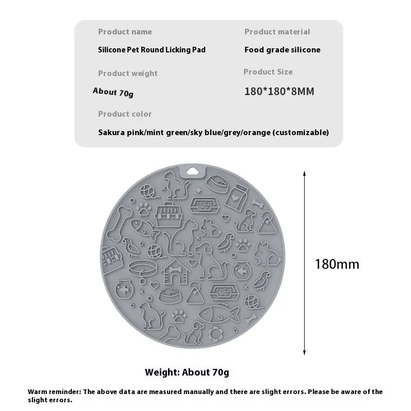 Round grey silicone pet lick mat with suction base on a kitchen floor
