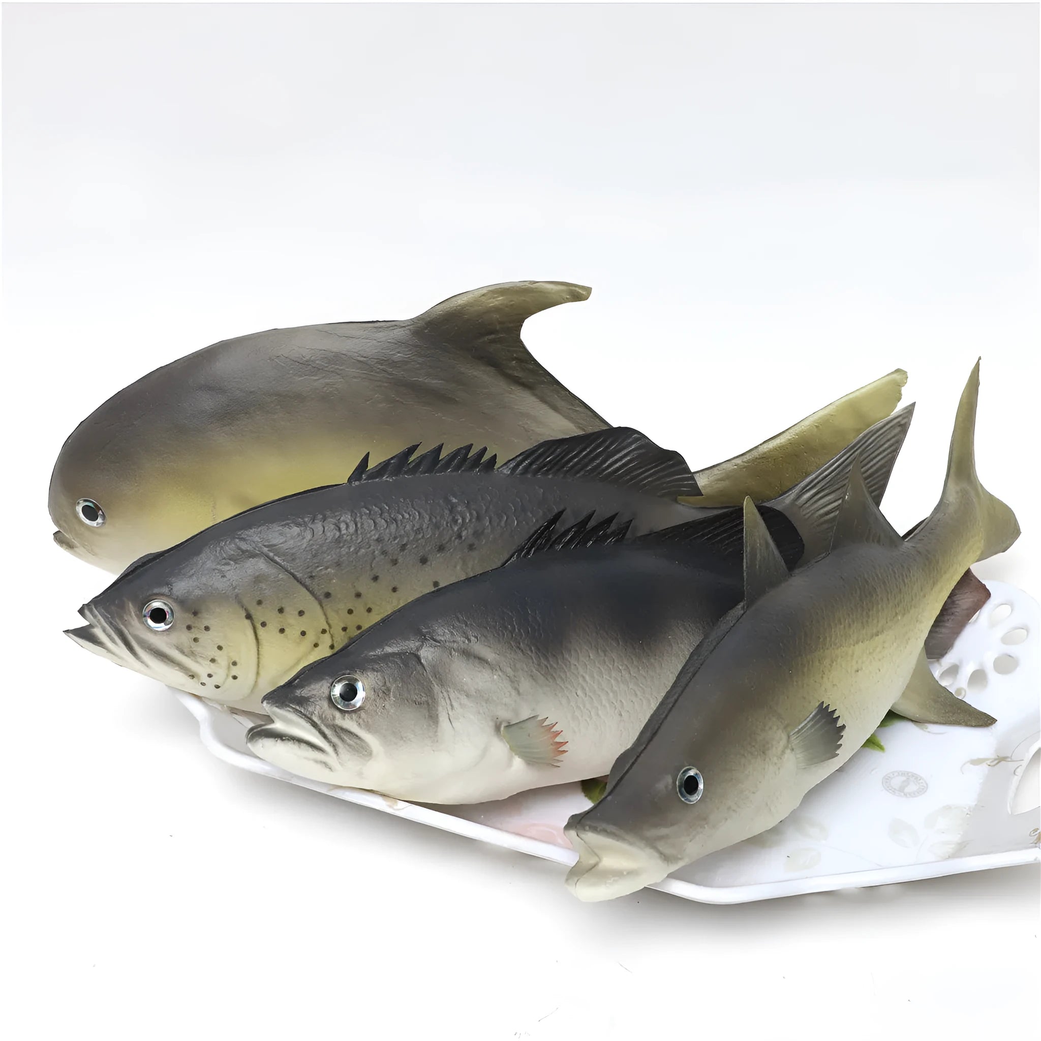 Set of four colourful PU simulated fish model ornaments including tuna and flower fish on a white background.