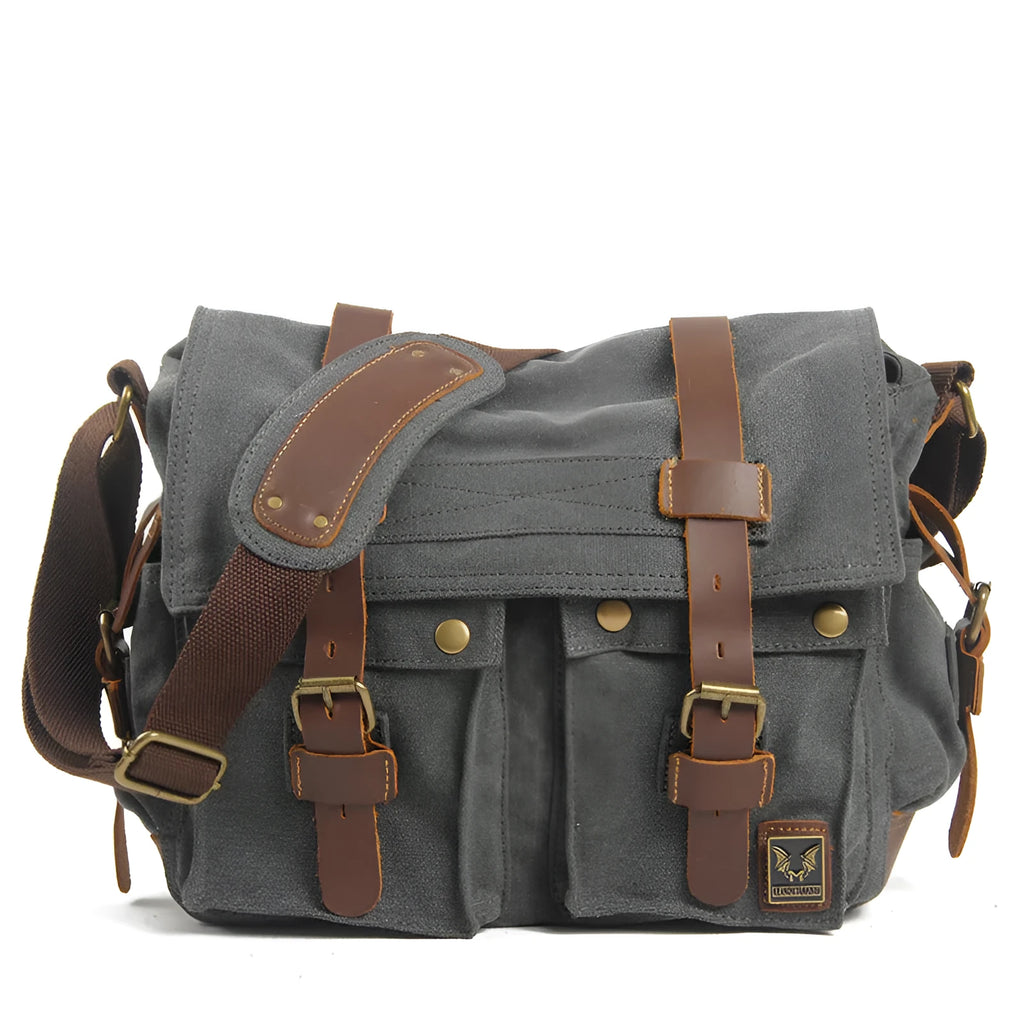 Men's retro-style canvas crossbody bag with cowhide trim in army green, showing flap closure and shoulder strap.