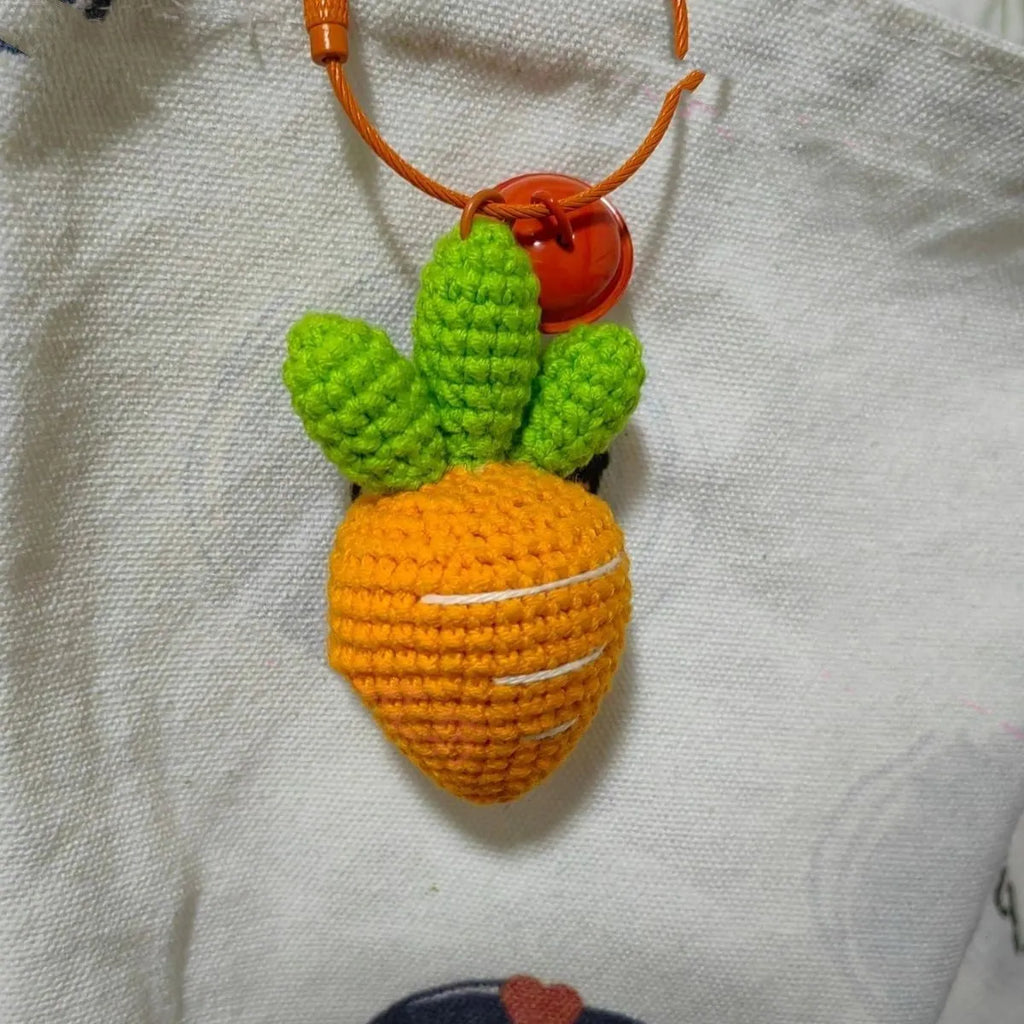 Soft wool keychain pendant shaped like a cartoon carrot car on a keyring.