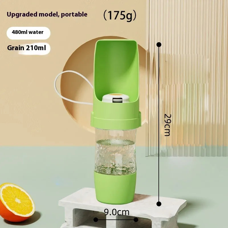 Green portable dog water bottle and feeder with attached lanyard, showing separate food and water compartments.