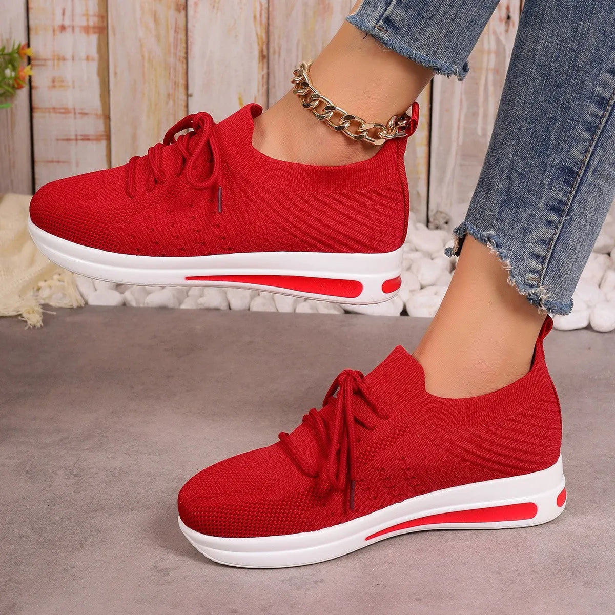 Women's low-top lace-up casual sneakers in red, black, and blue with a fly-knit pattern and round toe.
