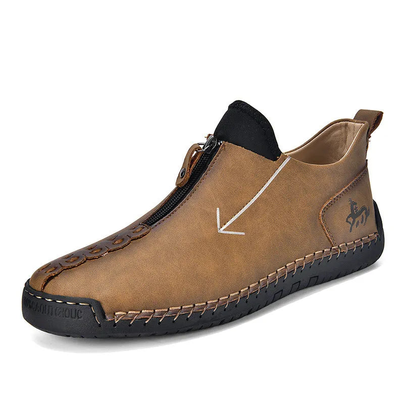 Men's black leather casual boot with front zip, round toe, and rubber sole on a white background.