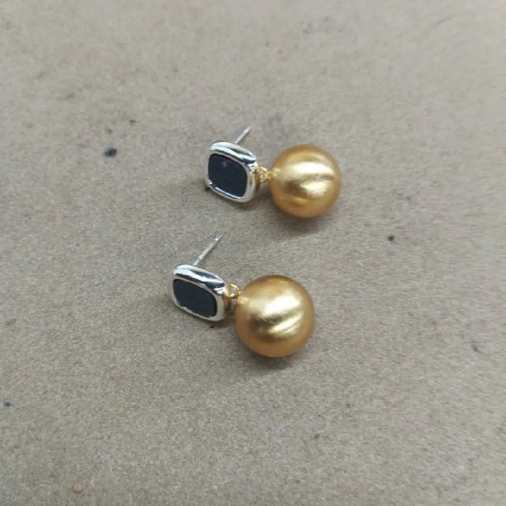 Women's copper matte geometric square round stud earrings in gold silver colour on neutral background