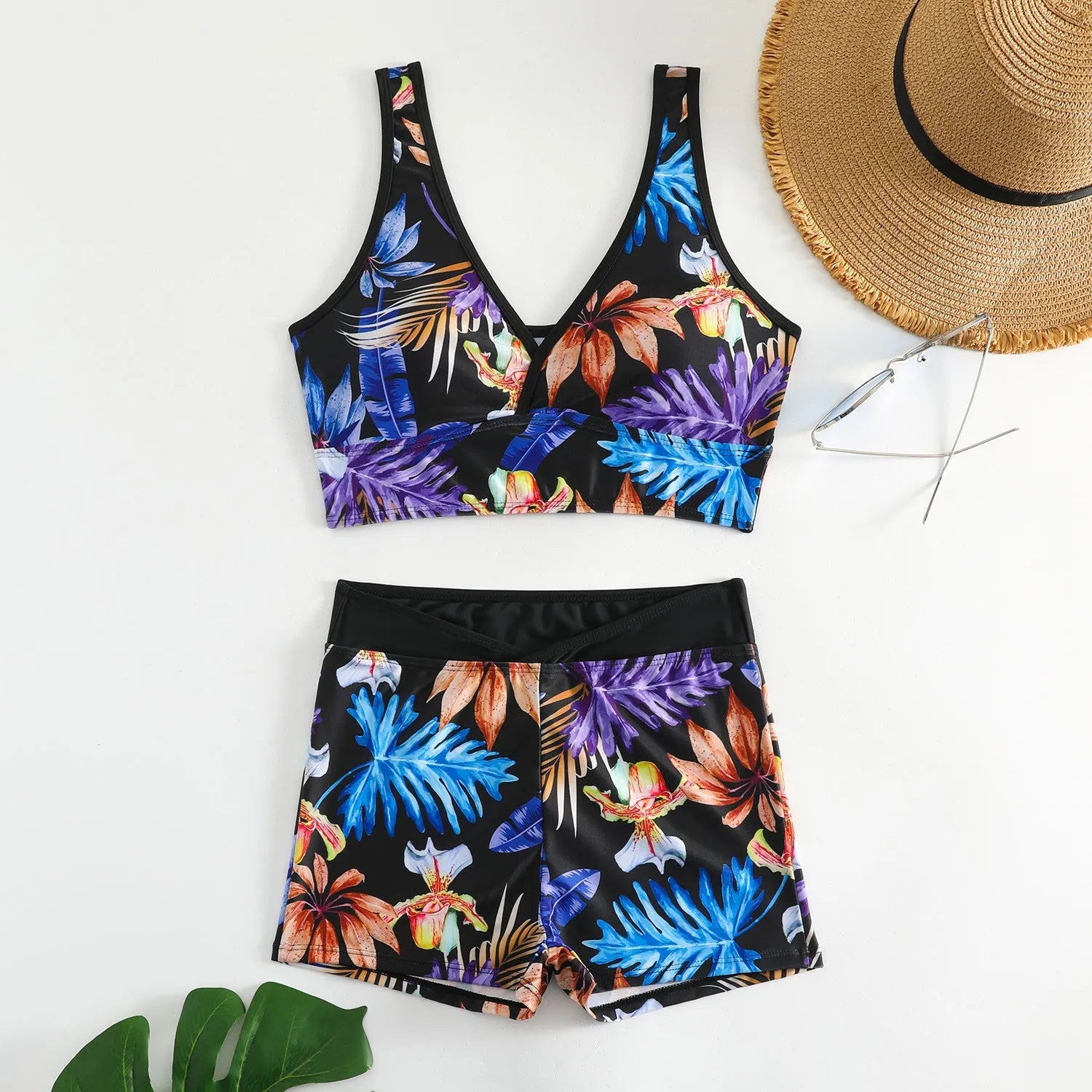 Women's two-piece swimsuit with sleeveless top and printed boxer brief bottoms in a multi-colour pattern.