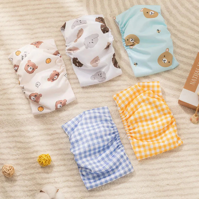Reusable cartoon bone print dog diaper with fastener tape and elastic waistband, shown in blue bear pattern.
