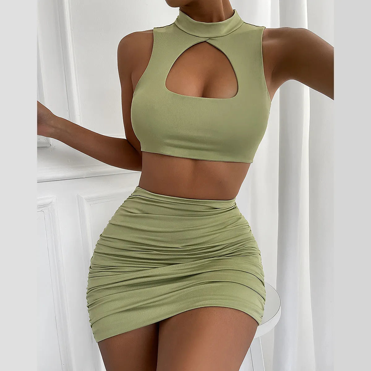 Light purple women's two-piece set featuring a hollow vest top and a matching split skirt on a model.