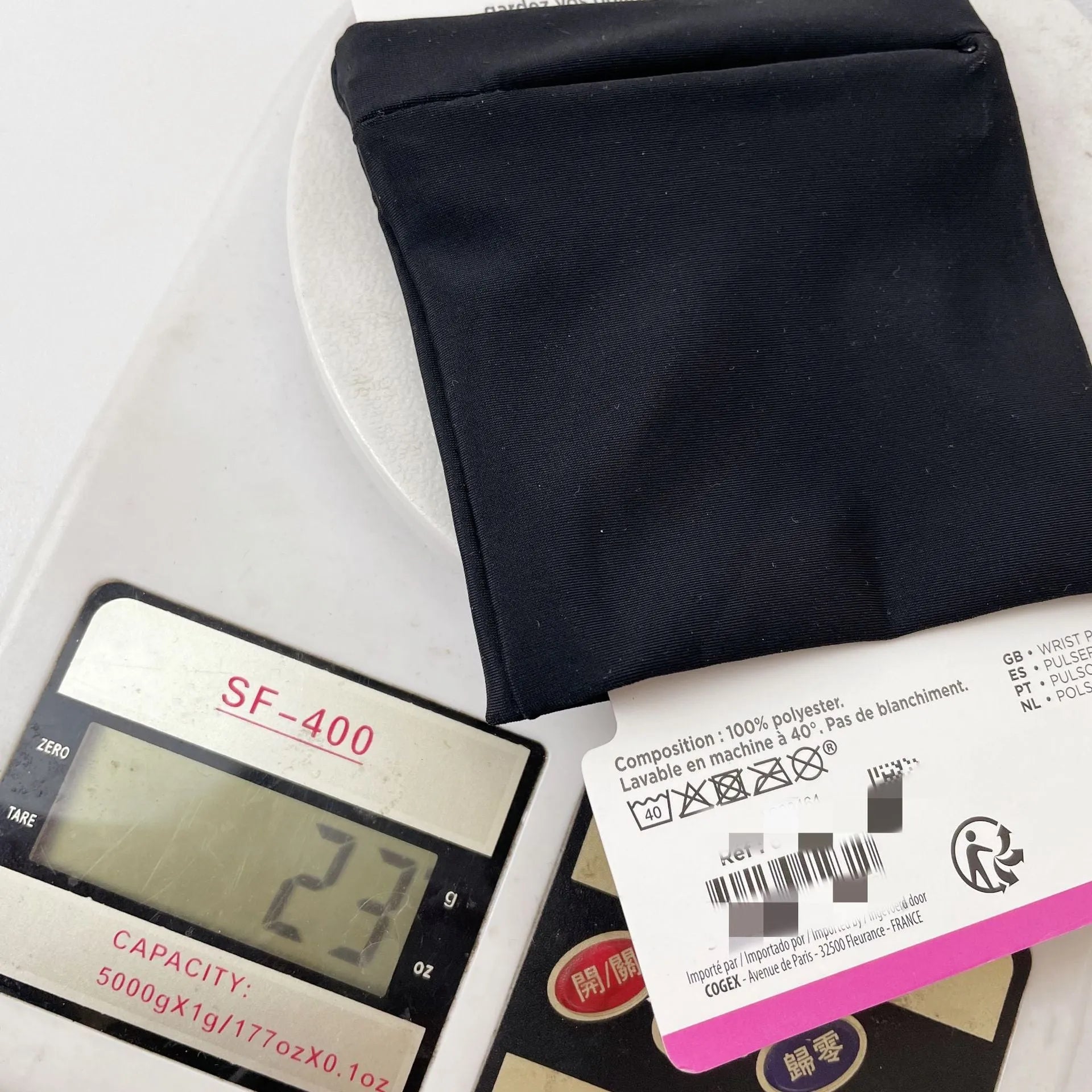 Black wrist bag armband sleeve with strap, showing 10cm by 10.5cm front pocket for a mobile phone.