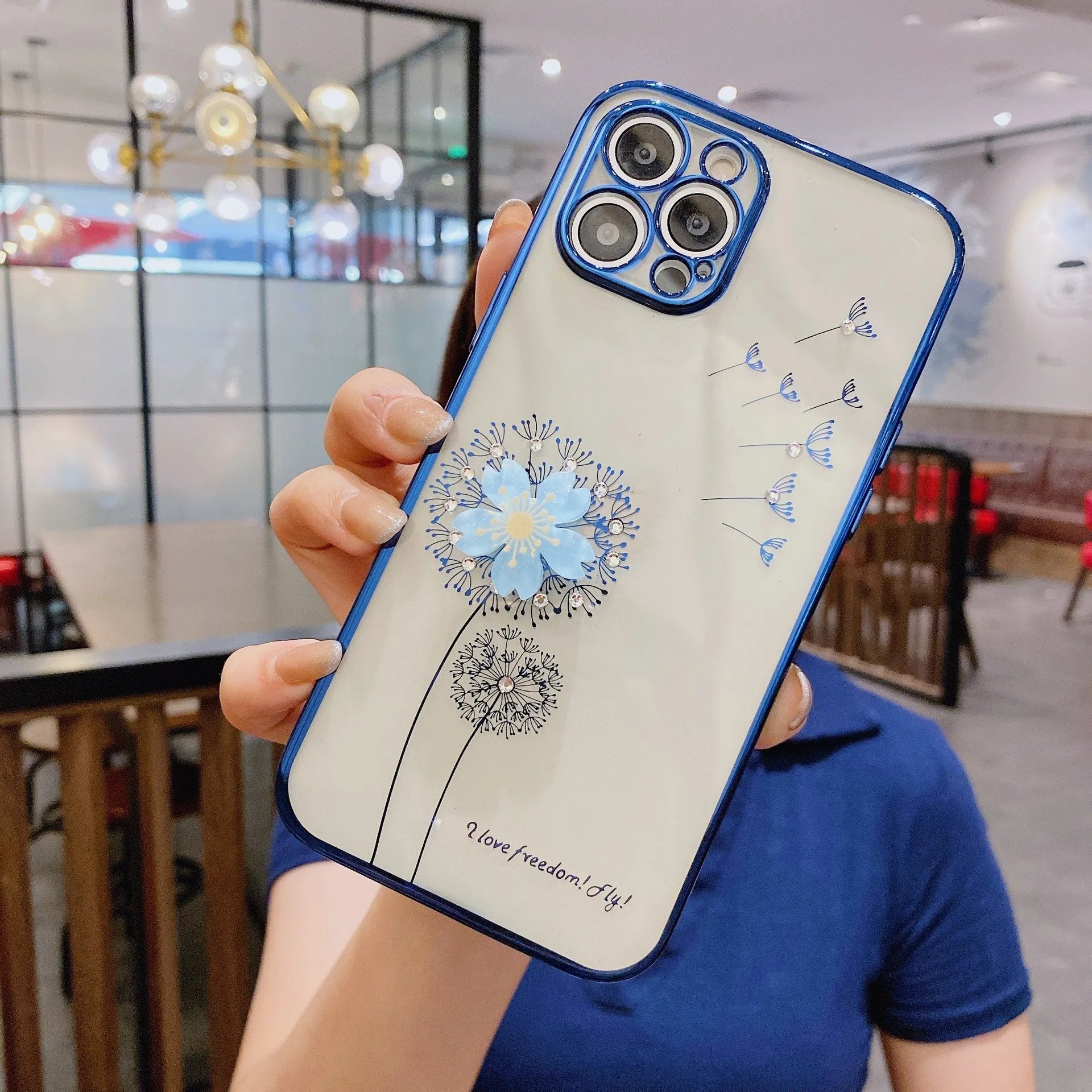 Green iPhone case with a raised 3D purple flower that acts as a spin stand, showing the built-in screen protector.
