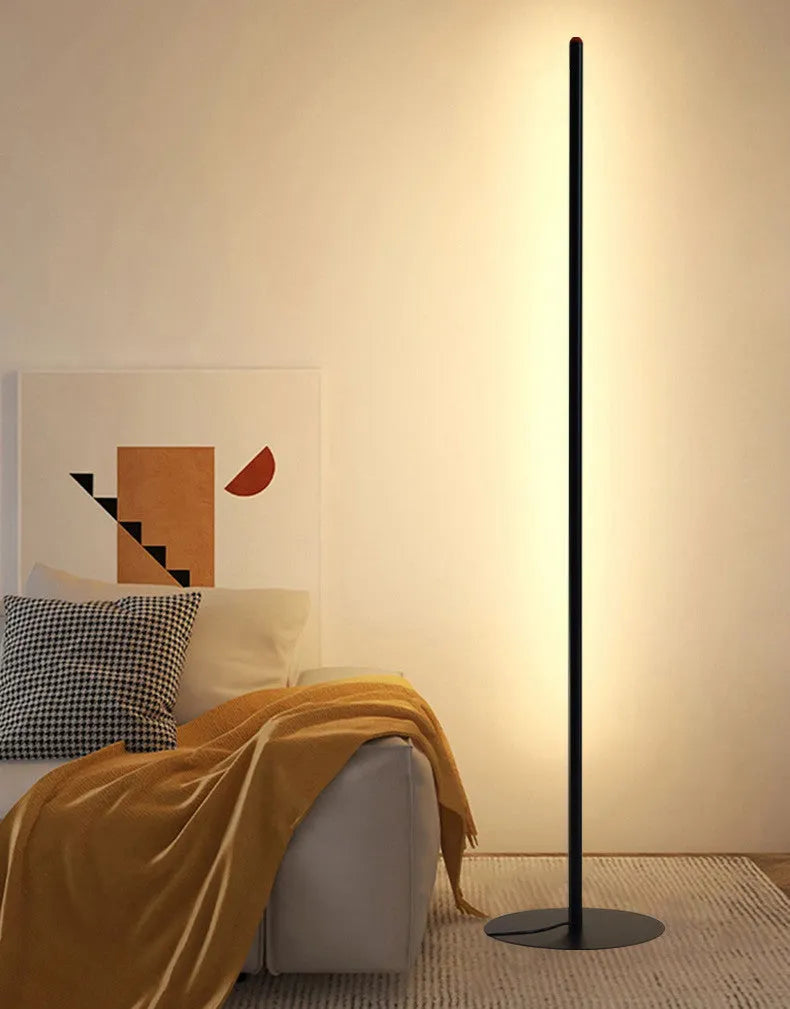 Simple modern vertical aluminium alloy floor lamp with LED light in a living room corner.