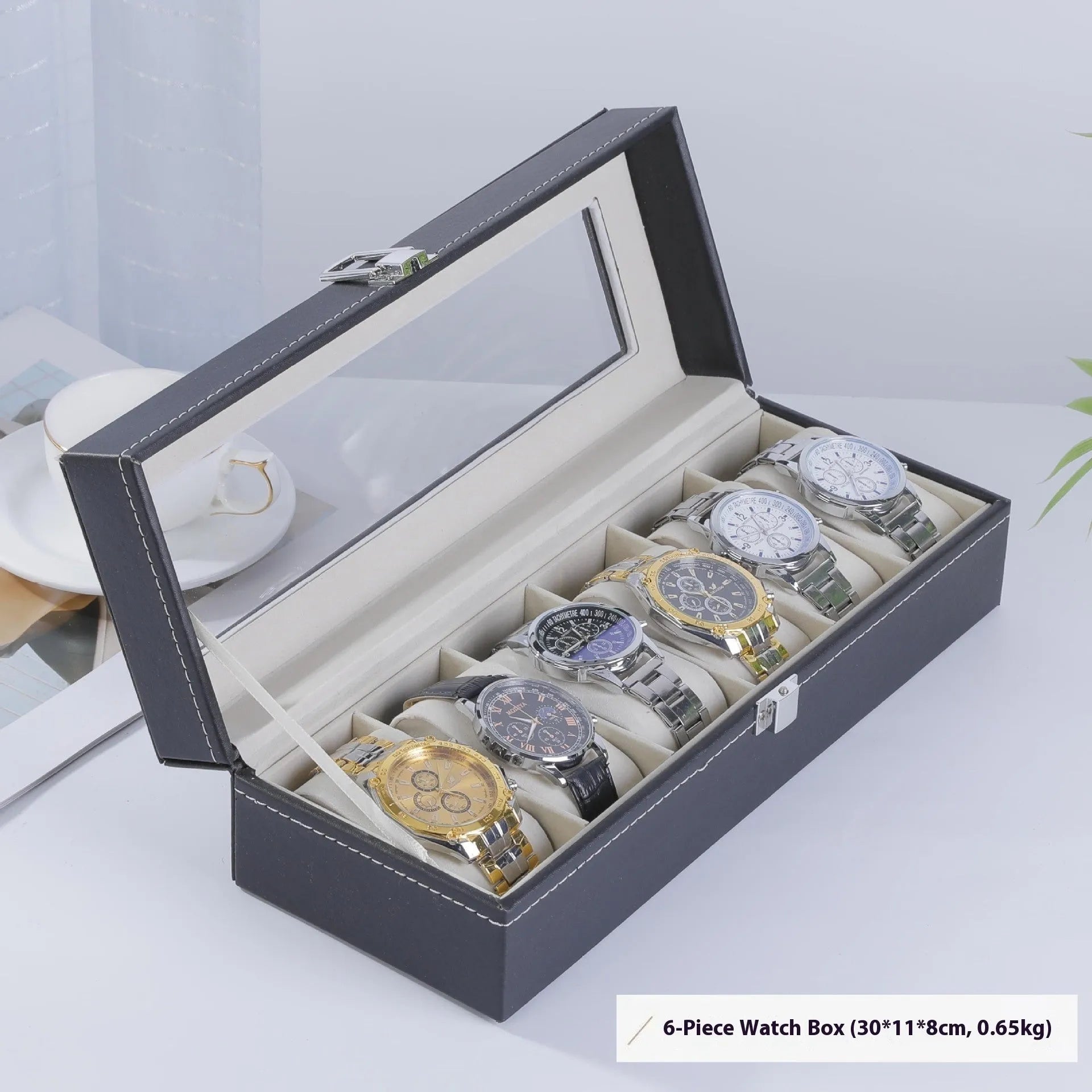 Grey leather watch storage box with a transparent dust cover, showing internal watch slots.