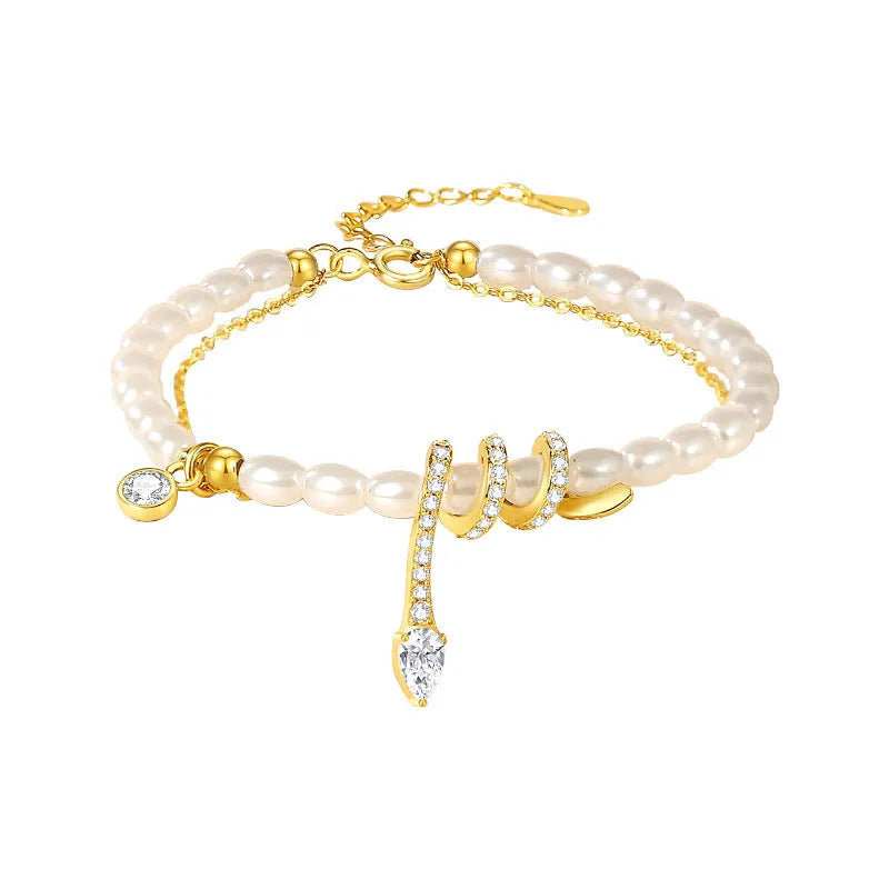Close-up of a women's silver bracelet with a detailed pearl snake design, shown in both gold and white gold colour options.