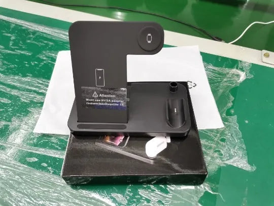 Black foldable 4-in-1 wireless charging stand showing iPhone charging vertically and Apple Pencil on its charging spot.