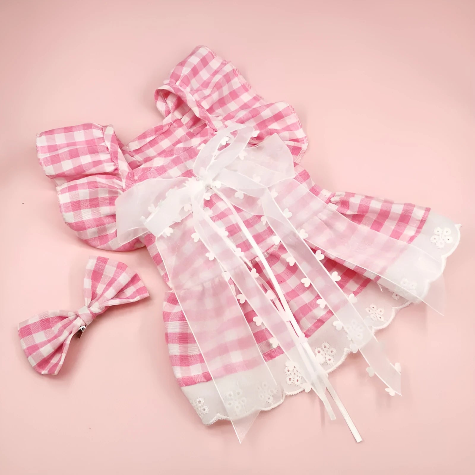 Breathable lace and plaid gauze dog skirt in Pink Daisy with matching bow necklace on a small dog