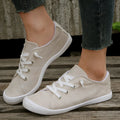 Women's beige low-top fabric casual sneakers with a rubber sole on a neutral background.