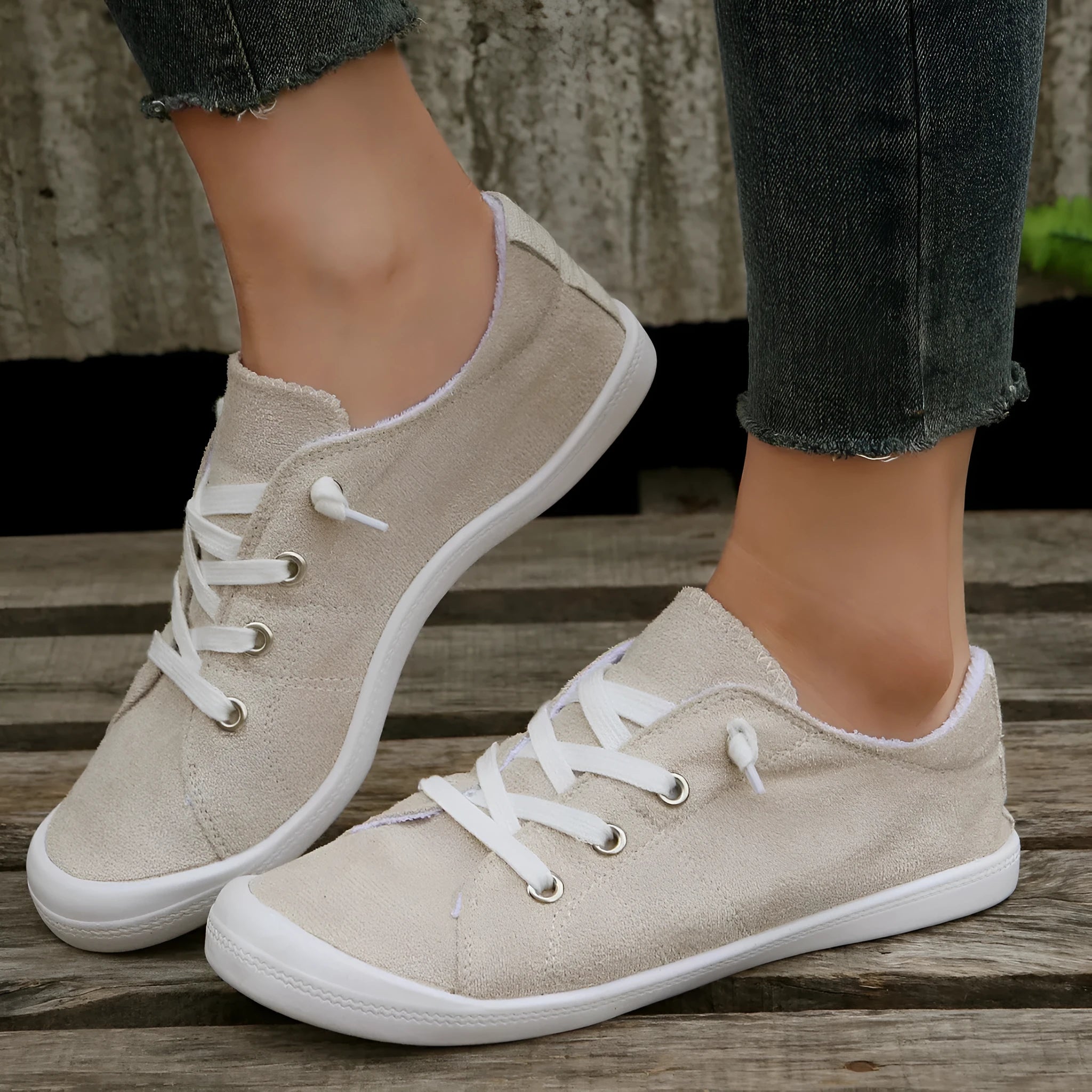 Women's beige low-top fabric casual sneakers with a rubber sole on a neutral background.