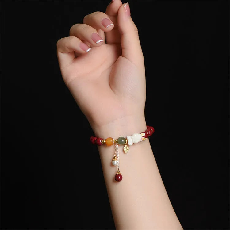 Traditional Chinese cinnabar bracelet with rabbit design in 8mm and 10mm bead size options.