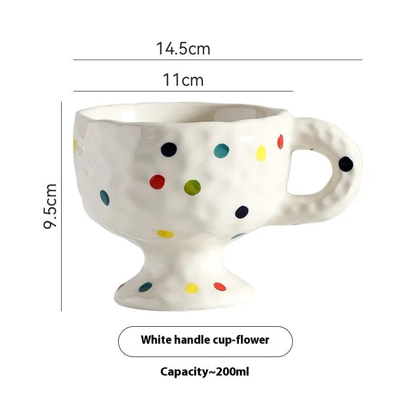 Hand-pinched irregular ceramic mug in a solid colour, showing its unique shape and modern design.