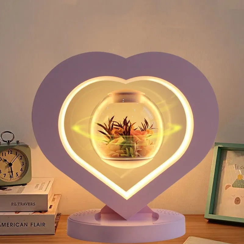 Pink preserved rose ornament with LED lights, shown with and without a decorative base.