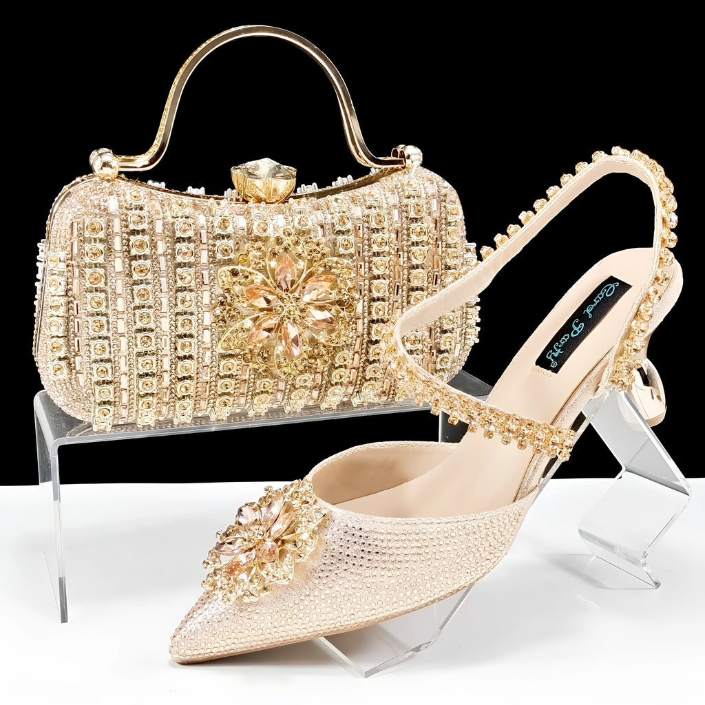 Women's black high heel shoe with floral rhinestone detail and matching hard clutch bag.