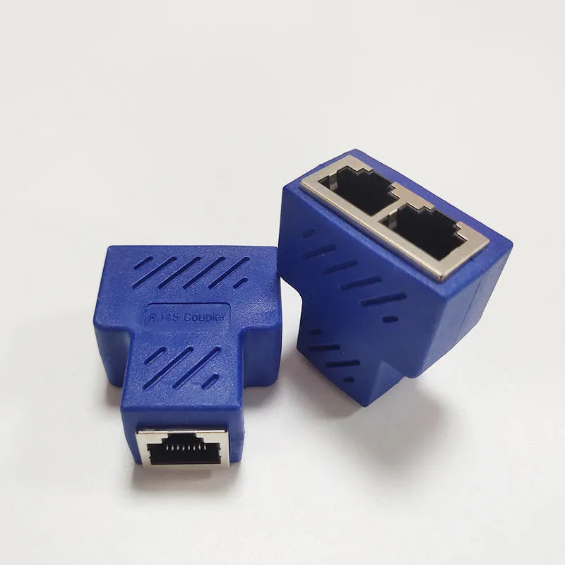 Two white RJ45 three-way tee network cable splitters on a surface