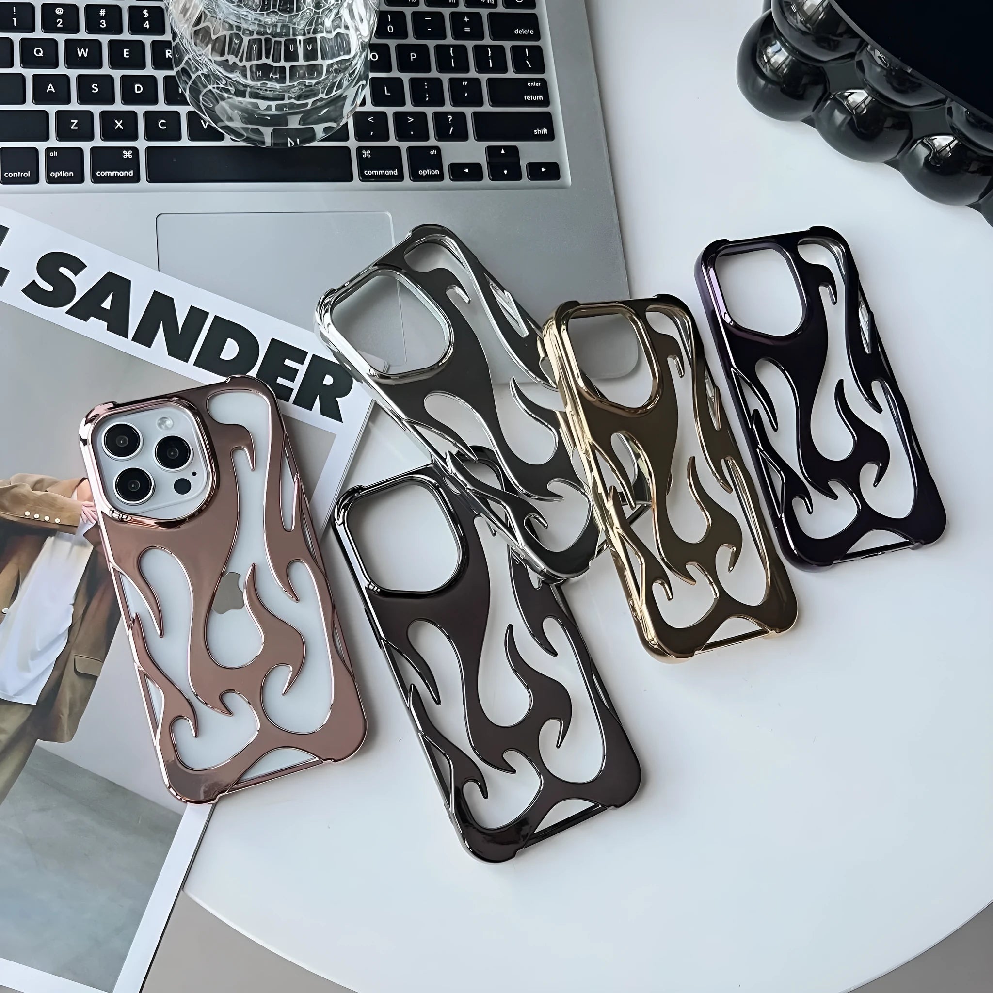 Electroplated hollow flame pattern phone case for iPhone, showing silver finish and perforated design for heat dissipation.